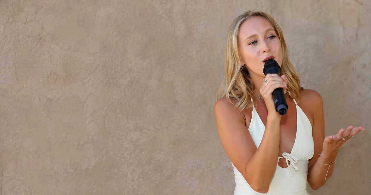 Ellie Lillian performing live with a microphone